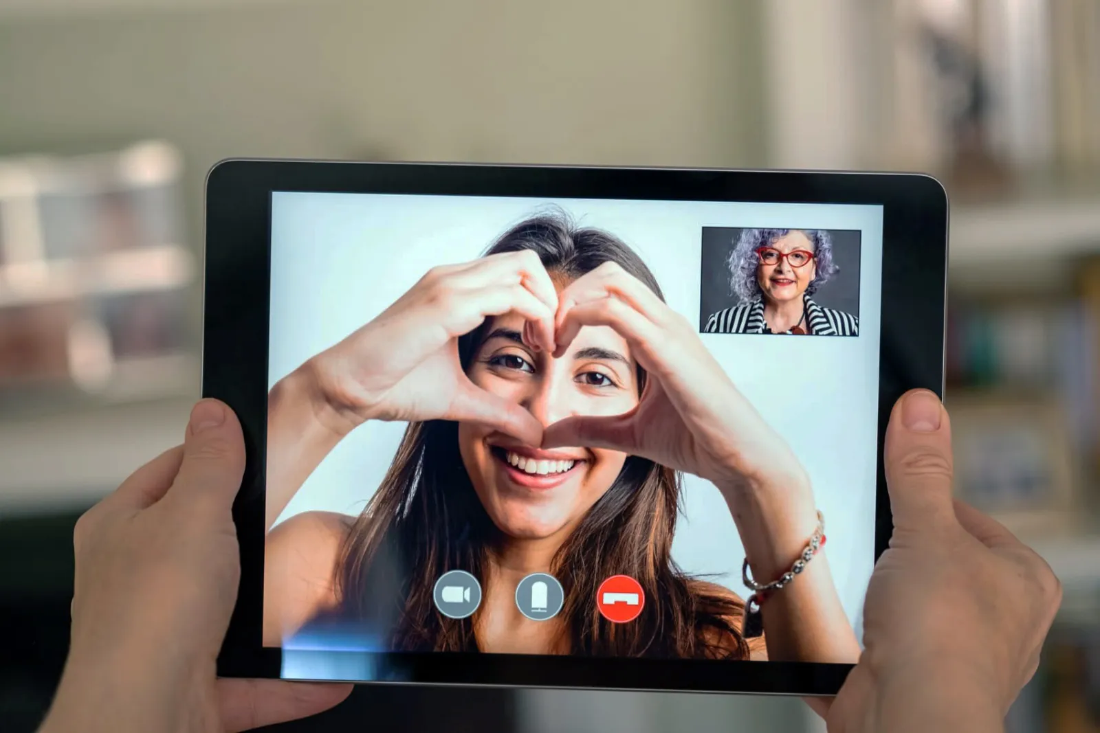 An older adult on a video call with family